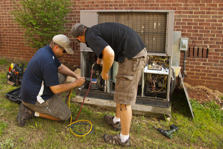 technicians working on hvac system